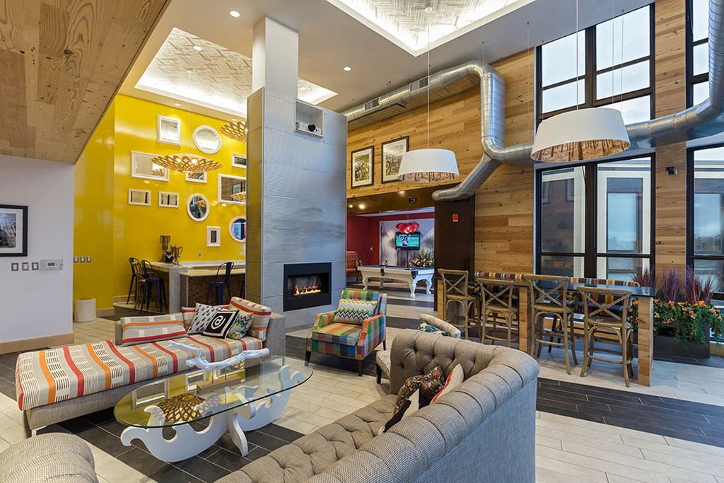 a living room with couches and chairs and a fireplace a living room with couches and chairs and a fireplace at Ann Arbor City Club, Ann Arbor, 48104